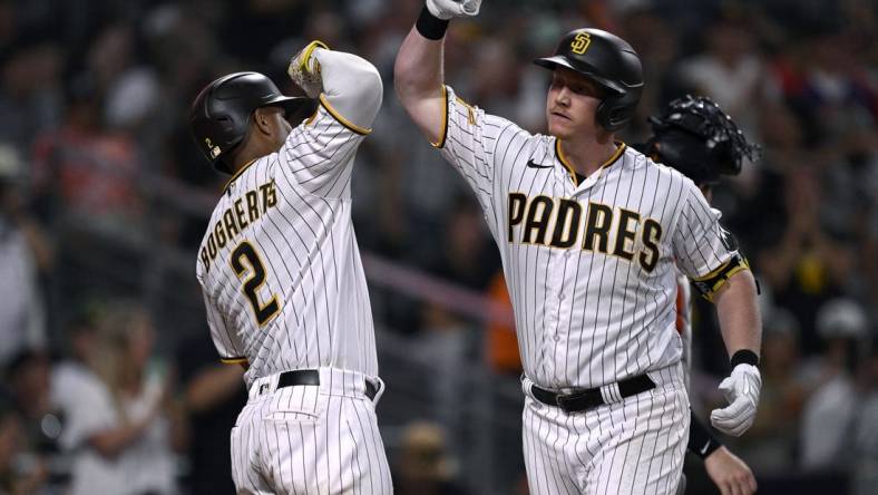 Sep 2, 2023; San Diego, California, USA; San Diego Padres first baseman Garrett Cooper (right) is congratulated by shortstop Xander Bogaerts (2) after hitting a three-run home run against the San Francisco Giants during the sixth inning at Petco Park. Mandatory Credit: Orlando Ramirez-USA TODAY Sports