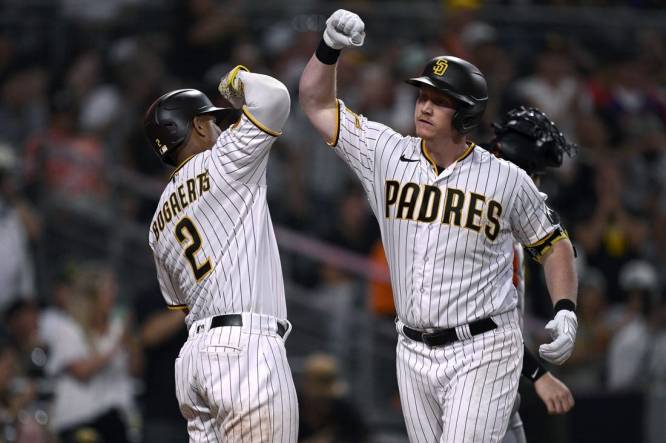 Sep 2, 2023; San Diego, California, USA; San Diego Padres first baseman Garrett Cooper (right) is congratulated by shortstop Xander Bogaerts (2) after hitting a three-run home run against the San Francisco Giants during the sixth inning at Petco Park. Mandatory Credit: Orlando Ramirez-USA TODAY Sports