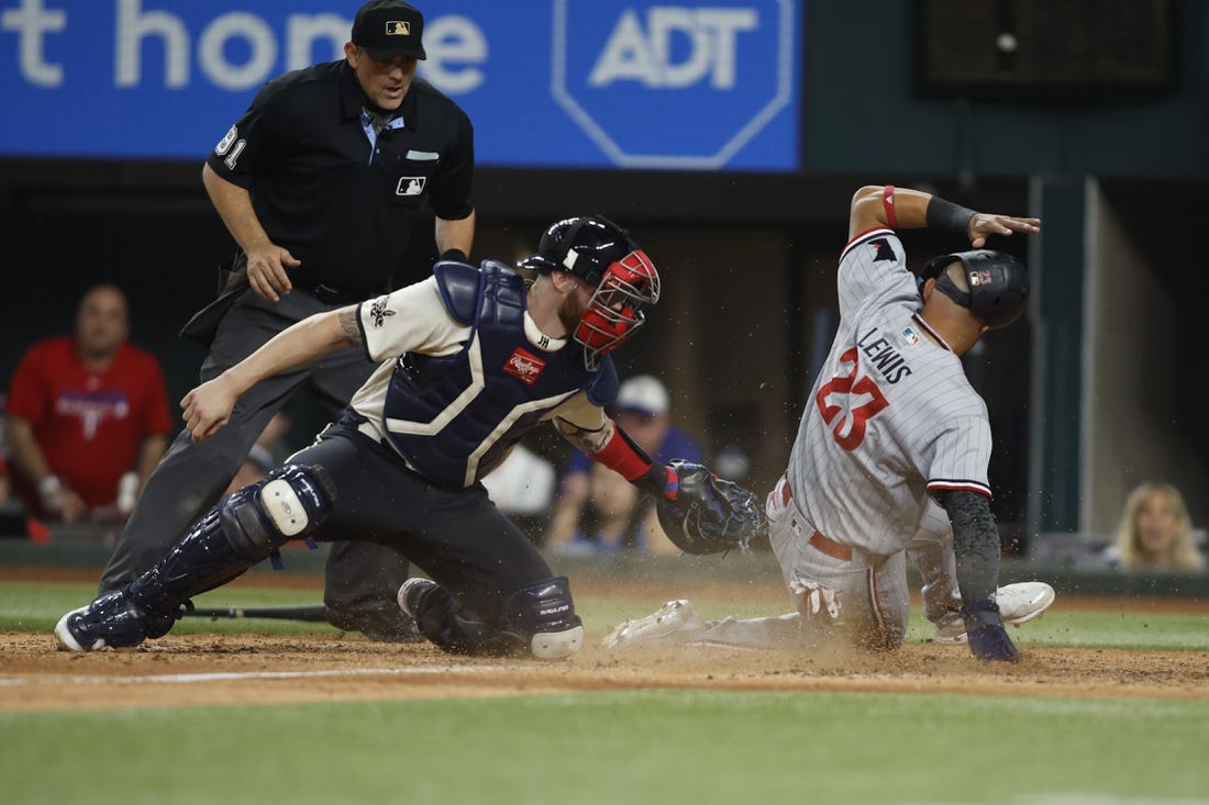 Sep 2, 2023; Arlington, Texas, USA; Minnesota Twins third baseman Royce Lewis (23) scores a run and avoids the tag of Texas Rangers catcher Jonah Heim (28) in the tenth inning at Globe Life Field. Mandatory Credit: Tim Heitman-USA TODAY Sports