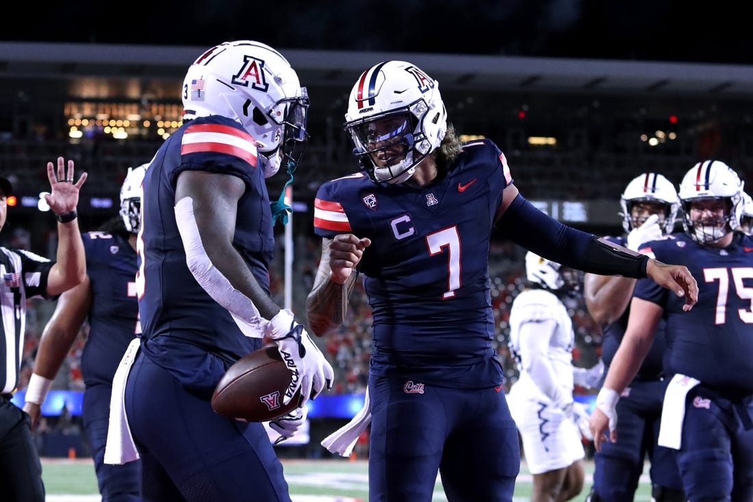 Sep 2, 2023; Tucson, Arizona, USA; Arizona Wildcats quarterback Jayden de Laura (7) celebrates a touchdown with running back Jonah Coleman (3) against the Northern Arizona Lumberjacks during the first half at Arizona Stadium. Mandatory Credit: Zac BonDurant-USA TODAY Sports