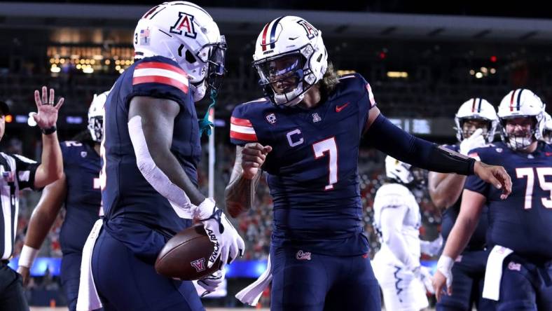 Sep 2, 2023; Tucson, Arizona, USA; Arizona Wildcats quarterback Jayden de Laura (7) celebrates a touchdown with running back Jonah Coleman (3) against the Northern Arizona Lumberjacks during the first half at Arizona Stadium. Mandatory Credit: Zac BonDurant-USA TODAY Sports