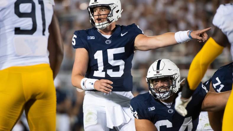 Penn State quarterback Drew Allar (15) and center Hunter Nourzad (64) point out a detail in the West Virginia defense during the season opener at Beaver Stadium September 2, 2023, in State College.