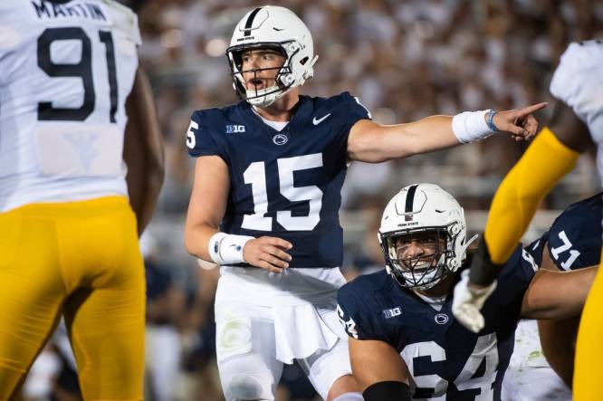 Penn State quarterback Drew Allar (15) and center Hunter Nourzad (64) point out a detail in the West Virginia defense during the season opener at Beaver Stadium September 2, 2023, in State College.