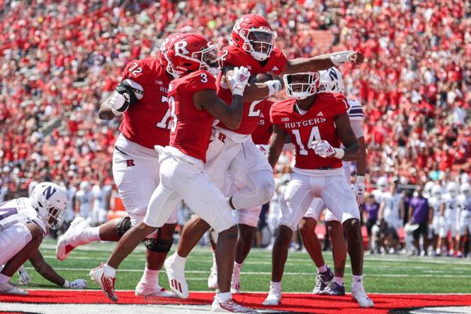 Sep 3, 2023; Piscataway, New Jersey, USA; Rutgers Scarlet Knights quarterback Gavin Wimsatt (2) celebrates his touchdown with teammates during the first half against the Northwestern Wildcats at SHI Stadium. Mandatory Credit: Vincent Carchietta-USA TODAY Sports