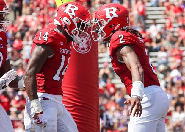 Sep 3, 2023; Piscataway, New Jersey, USA; Rutgers Scarlet Knights quarterback Gavin Wimsatt (2) celebrates his touchdown with wide receiver Isaiah Washington (14) during the first half against the Northwestern Wildcats at SHI Stadium. Mandatory Credit: Vincent Carchietta-USA TODAY Sports