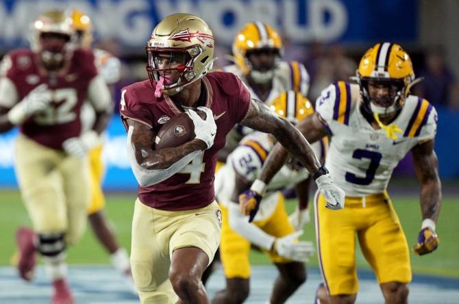 Sep 3, 2023; Orlando, Florida, USA; Florida State Seminoles wide receiver Keon Coleman (4) runs the ball for a touchdown during the first half against the Louisiana State Tigers at Camping World Stadium. Mandatory Credit: Melina Myers-USA TODAY Sports