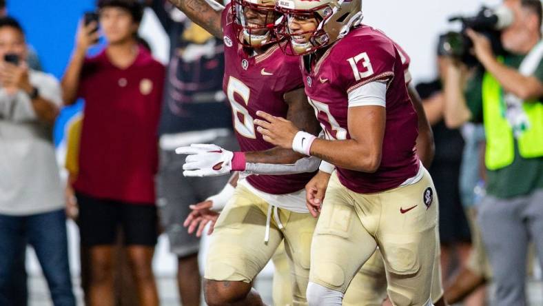 Florida State Seminoles tight end Jaheim Bell (6) and Florida State Seminoles quarterback Jordan Travis (13) celebrate a touchdown during a game against the LSU Tigers on Sunday, Sept. 3, 2023.