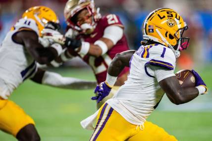 LSU's Aaron Anderson runs with the ball against the Florida State Seminoles 17-14 at the half of the Camping World Kickoff on Sunday, Sept. 3, 2023.