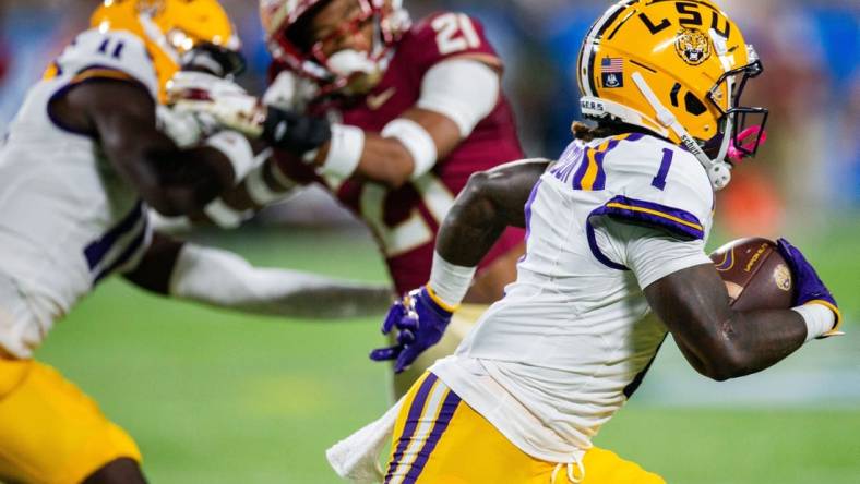 LSU's Aaron Anderson runs with the ball against the Florida State Seminoles 17-14 at the half of the Camping World Kickoff on Sunday, Sept. 3, 2023.