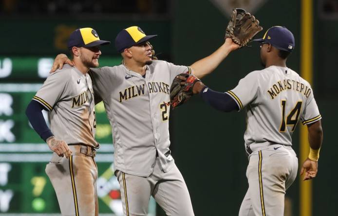 Sep 5, 2023; Pittsburgh, Pennsylvania, USA; Milwaukee Brewers second baseman Brice Turang (2) and shortstop Willy Adames (27) and third baseman Andruw Monasterio (14) celebrate after defeating the Pittsburgh Pirates at PNC Park. The Brewers won 7-3. Mandatory Credit: Charles LeClaire-USA TODAY Sports