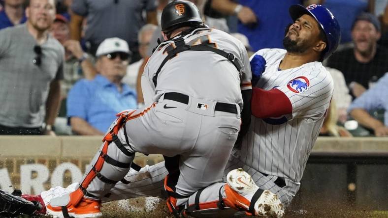 Sep 5, 2023; Chicago, Illinois, USA;Chicago Cubs third baseman Jeimer Candelario (9) is safe at home plate as San Francisco Giants catcher Patrick Bailey (14) can   t catch the ball during the seventh inning  at Wrigley Field. Mandatory Credit: David Banks-USA TODAY Sports