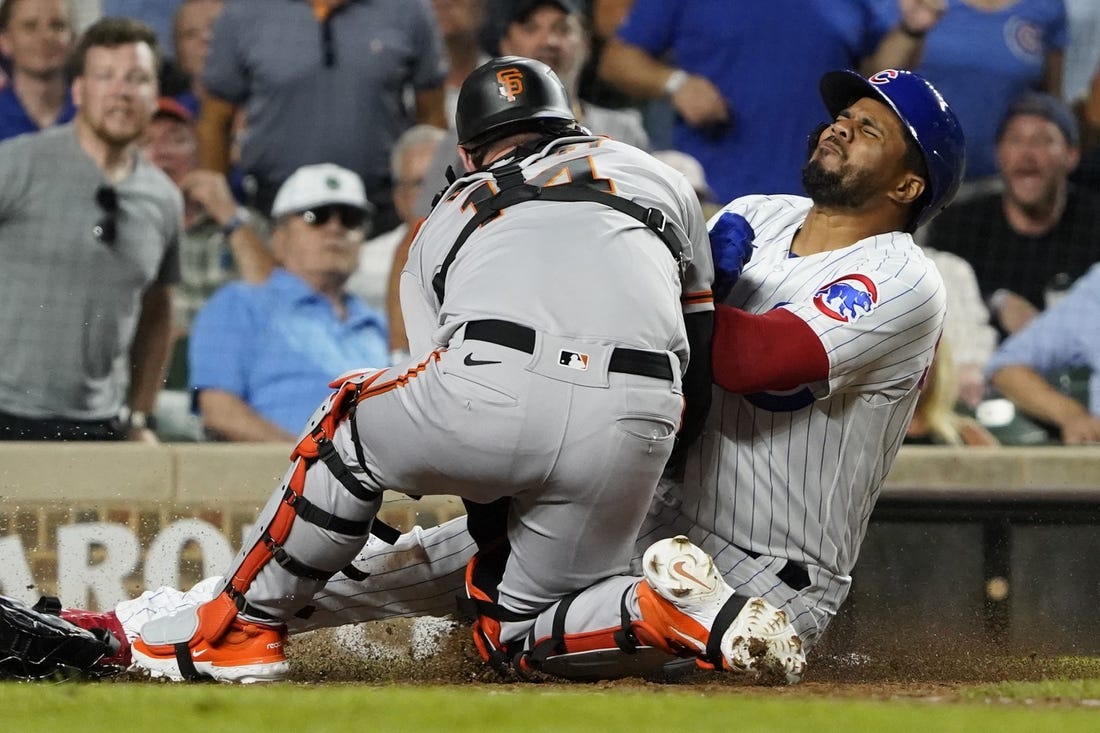 Sep 5, 2023; Chicago, Illinois, USA;Chicago Cubs third baseman Jeimer Candelario (9) is safe at home plate as San Francisco Giants catcher Patrick Bailey (14) can   t catch the ball during the seventh inning  at Wrigley Field. Mandatory Credit: David Banks-USA TODAY Sports