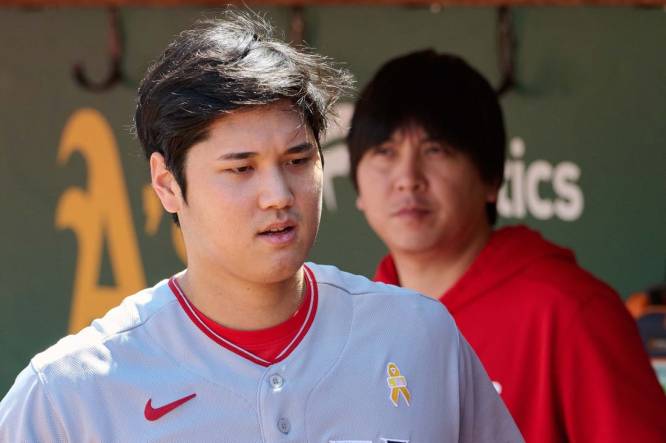 Sep 3, 2023; Oakland, California, USA; Los Angeles Angels designated hitter Shohei Ohtani (17) and interpreter Ippei Mizuhara stand in the dugout before the game between the Los Angeles Angels and the Oakland Athletics at Oakland-Alameda County Coliseum. Mandatory Credit: Robert Edwards-USA TODAY Sports