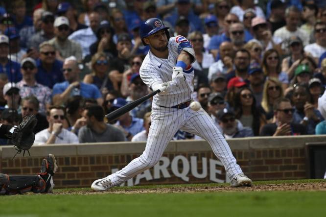 Sep 6, 2023; Chicago, Illinois, USA;  Chicago Cubs third baseman Nick Madrigal (1) hits an RBI single against the San Francisco Giants during the third inning at Wrigley Field. Mandatory Credit: Matt Marton-USA TODAY Sports