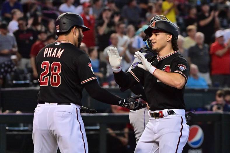 Tommy Pham of the Arizona Diamondbacks gestures to players from