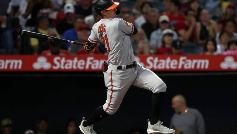 Sep 6, 2023; Anaheim, California, USA;  Baltimore Orioles left fielder Austin Hays (21) hits an RBI single during the third inning against the Los Angeles Angels at Angel Stadium. Mandatory Credit: Kiyoshi Mio-USA TODAY Sports