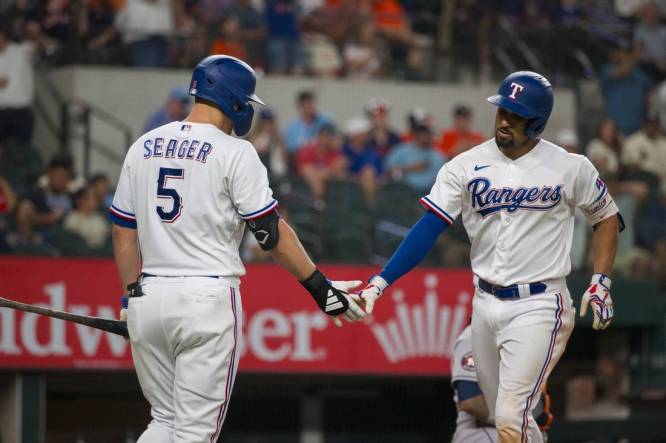 Sep 6, 2023; Arlington, Texas, USA; Texas Rangers shortstop Corey Seager (5) and second baseman Marcus Semien (2) celebrate after Semien hits a home run against the Houston Astros at Globe Life Field. Mandatory Credit: Jerome Miron-USA TODAY Sports