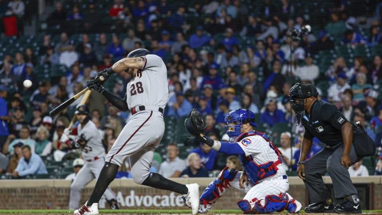 Sep 7, 2023; Chicago, Illinois, USA; Arizona Diamondbacks left fielder Tommy Pham (28) hits a solo home run against the Chicago Cubs during the first inning at Wrigley Field. Mandatory Credit: Kamil Krzaczynski-USA TODAY Sports