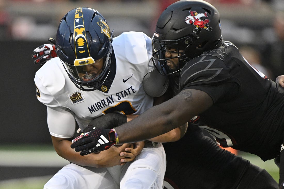 Sep 7, 2023; Louisville, Kentucky, USA; Louisville Cardinals defensive lineman Dezmond Tell (99) sacks Murray State Racers quarterback DJ Williams (2) during the first quarter at L&N Federal Credit Union Stadium. Mandatory Credit: Jamie Rhodes-USA TODAY Sports