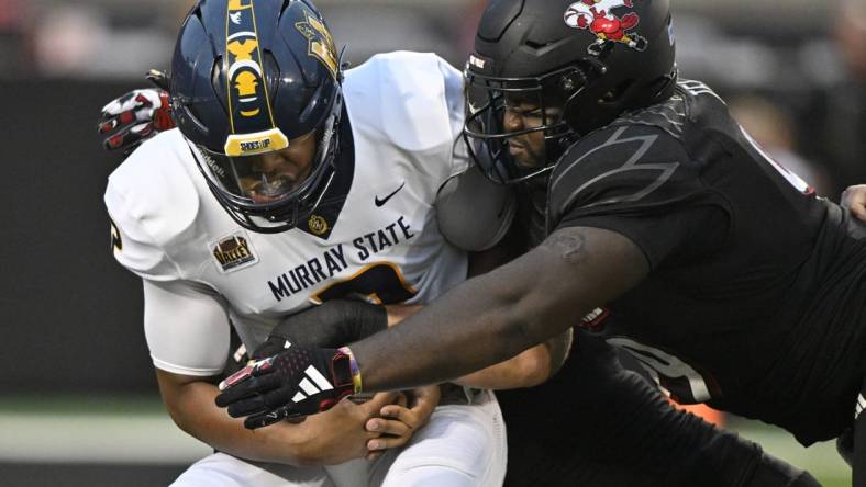 Sep 7, 2023; Louisville, Kentucky, USA; Louisville Cardinals defensive lineman Dezmond Tell (99) sacks Murray State Racers quarterback DJ Williams (2) during the first quarter at L&N Federal Credit Union Stadium. Mandatory Credit: Jamie Rhodes-USA TODAY Sports