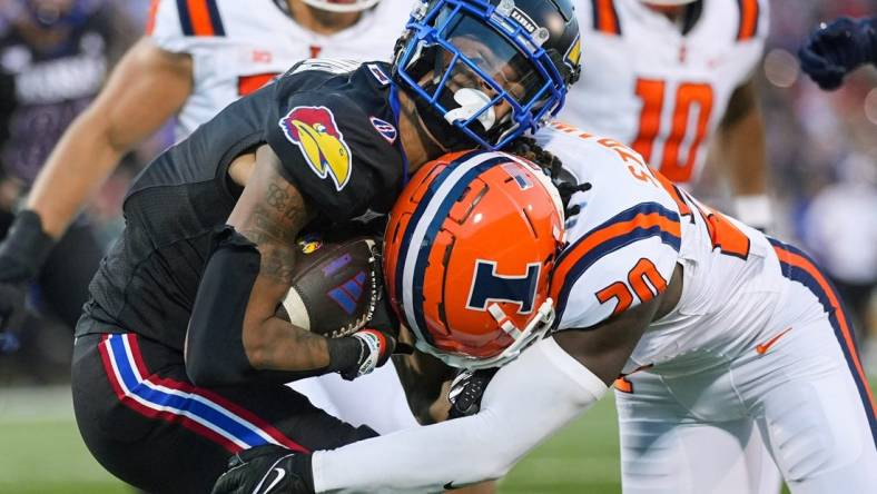 Sep 8, 2023; Lawrence, Kansas, USA; Kansas Jayhawks wide receiver Quentin Skinner (0) is tackled by Illinois Fighting Illini defensive back Tyler Strain (20) during the first half at David Booth Kansas Memorial Stadium. Mandatory Credit: Jay Biggerstaff-USA TODAY Sports