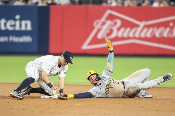 Sep 8, 2023; Bronx, New York, USA;   New York Yankees shortstop Anthony Volpe (11) drops the ball allowing Milwaukee Brewers catcher William Contreras (24) to steal second in the seventh inning at Yankee Stadium. Mandatory Credit: Wendell Cruz-USA TODAY Sports