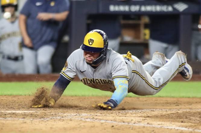 Sep 8, 2023; Bronx, New York, USA;  Milwaukee Brewers catcher William Contreras (24) slides safely at home in the seventh inning against the New York Yankees at Yankee Stadium. Mandatory Credit: Wendell Cruz-USA TODAY Sports