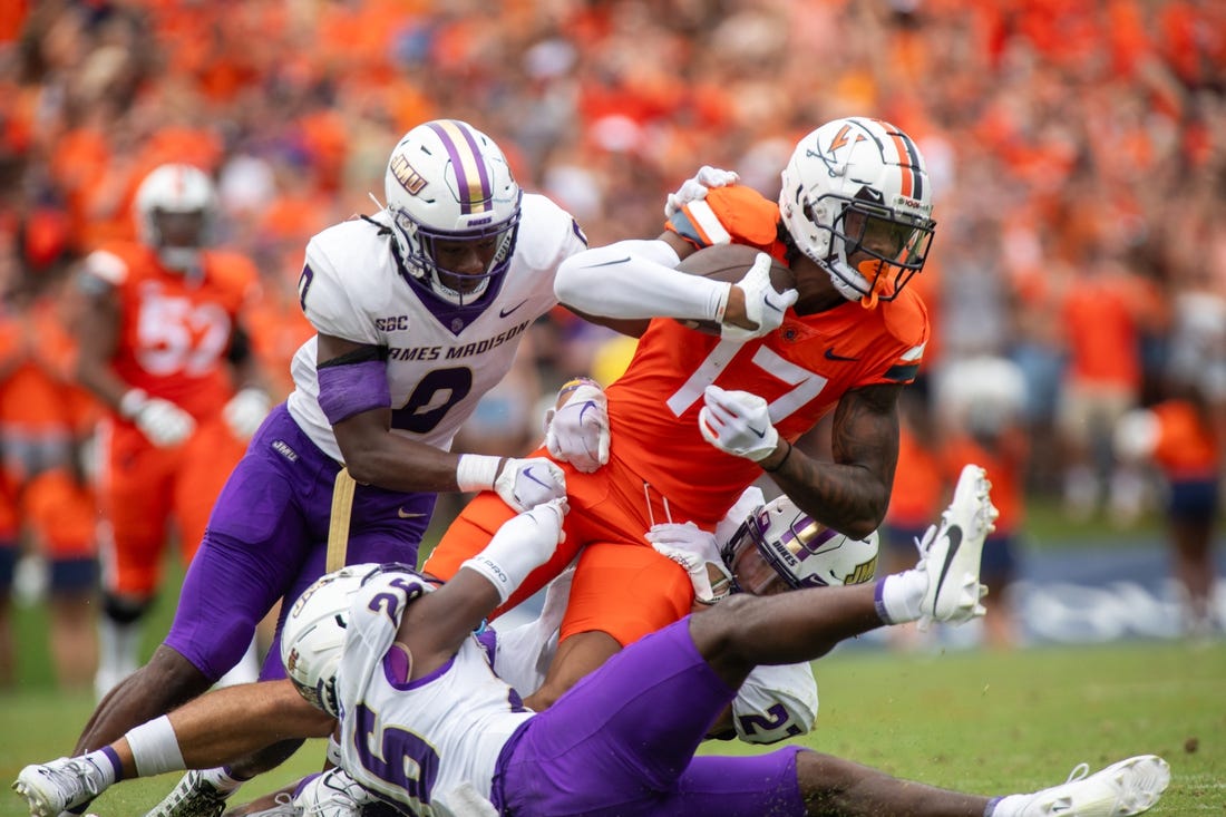 September 9, 2023 in Charlottesvile, Virginia; Virginia Cavaliers wide receiver JR Wilson (17) is tackled by James Madison Dukes linebacker Taurus Jones (0) in the first half at Scott Stadium. Mandatory Credit: Hannah Pajewski-USA TODAY Sports