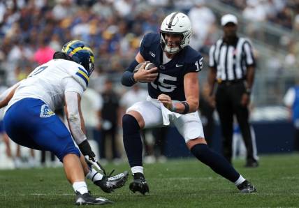 Sep 9, 2023; University Park, Pennsylvania, USA; Penn State Nittany Lions quarterback Drew Allar (15) looks to avoid a tackle while running with the ball during the first quarter against the Delaware Fightin' Blue Hens at Beaver Stadium. Mandatory Credit: Matthew O'Haren-USA TODAY Sports