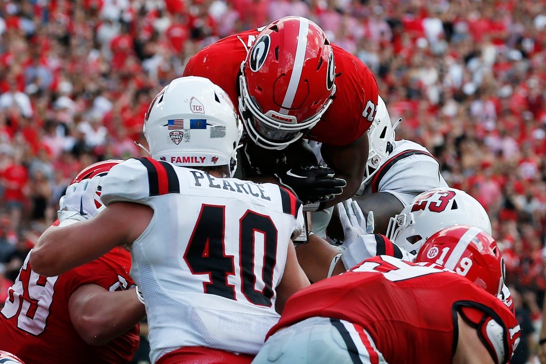 Georgia running back Kendall Milton (2) goes over the top to score a touchdown during the first half of a NCAA college football game against Ball State in Athens, Ga., on Saturday, Sept. 9, 2023.