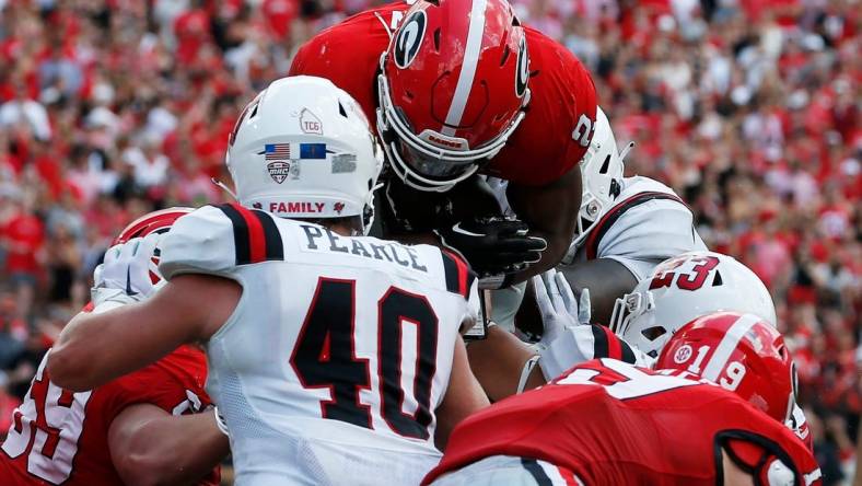 Georgia running back Kendall Milton (2) goes over the top to score a touchdown during the first half of a NCAA college football game against Ball State in Athens, Ga., on Saturday, Sept. 9, 2023.