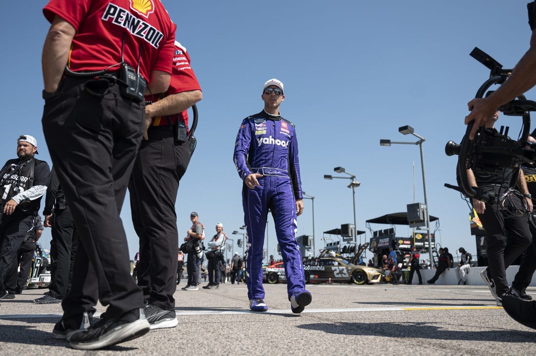 Sep 9, 2023; Kansas City, Kansas, USA; NASCAR Cup Series driver Denny Hamlin (11) walks to his car during NASCAR Cup Qualifying at Kansas Speedway. Mandatory Credit: Amy Kontras-USA TODAY Sports