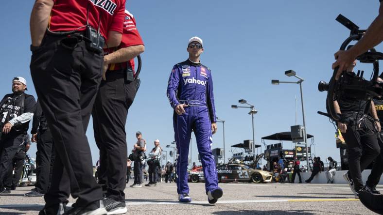 Sep 9, 2023; Kansas City, Kansas, USA; NASCAR Cup Series driver Denny Hamlin (11) walks to his car during NASCAR Cup Qualifying at Kansas Speedway. Mandatory Credit: Amy Kontras-USA TODAY Sports