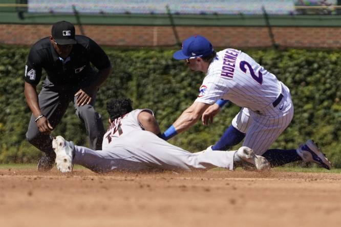 Sep 9, 2023; Chicago, Illinois, USA; Arizona Diamondbacks catcher Gabriel Moreno (14) steals second base as Chicago Cubs second baseman Nico Hoerner (2) makes a late tag during the third inning at Wrigley Field. Mandatory Credit: David Banks-USA TODAY Sports