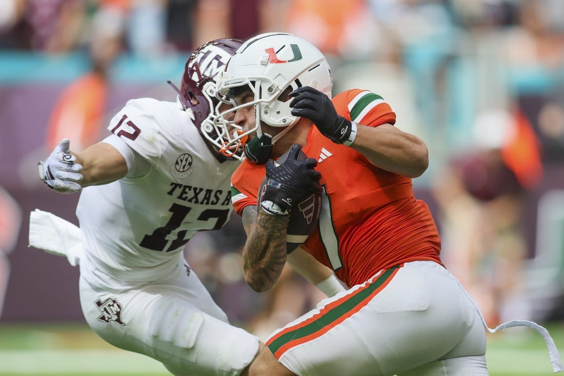 Sep 9, 2023; Miami Gardens, Florida, USA; Miami Hurricanes wide receiver Xavier Restrepo (7) runs with the football against the Texas A&M Aggies during the first quarter at Hard Rock Stadium. Mandatory Credit: Sam Navarro-USA TODAY Sports