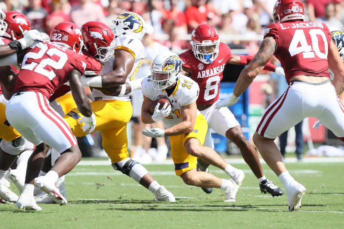 Sep 9, 2023; Fayetteville, Arkansas, USA; Kent State Golden Flashes running back Gavin Garcia (21) rushes in the first quarter against the Arkansas Razorbacks at Donald W. Reynolds Razorback Stadium. Mandatory Credit: Nelson Chenault-USA TODAY Sports