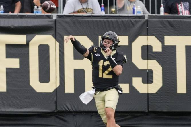 Sep 9, 2023; Winston-Salem, North Carolina, USA; Wake Forest Demon Deacons quarterback Mitch Griffis (12) passes near the end zone during the second half against the Vanderbilt Commodores at Allegacy Federal Credit Union Stadium. Mandatory Credit: Jim Dedmon-USA TODAY Sports