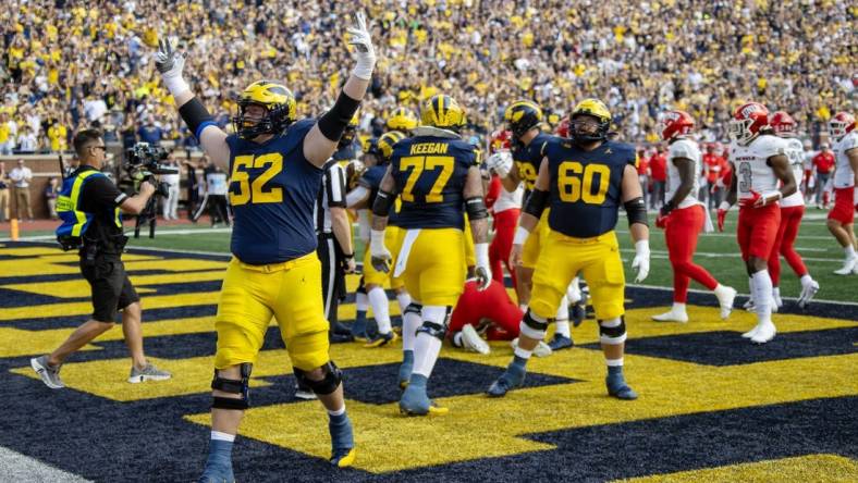 Sep 9, 2023; Ann Arbor, Michigan, USA; Michigan Wolverines defensive end Kechaun Bennett (52) celebrates running back Blake Corum   s (2) touchdown during the first half at Michigan Stadium. Mandatory Credit: David Reginek-USA TODAY Sports