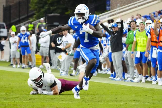 Sep 9, 2023; Durham, North Carolina, USA;  Duke Blue Devils running back Jordan Waters (7) makes a catch past Lafayette Leopards linebacker Preston Forney (18) during the first half at Wallace Wade Stadium. Mandatory Credit: James Guillory-USA TODAY Sports