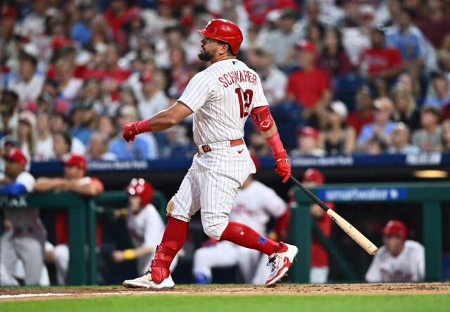 Sep 9, 2023; Philadelphia, Pennsylvania, USA; Philadelphia Phillies outfielder Kyle Schwarber (12) hits a three-run home run against the Miami Marlins in the second inning at Citizens Bank Park. Mandatory Credit: Kyle Ross-USA TODAY Sports