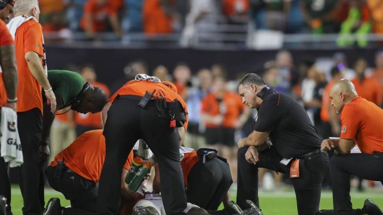 Sep 9, 2023; Miami Gardens, Florida, USA; Miami Hurricanes head coach Mario Cristobal looks on as trainers check on Miami Hurricanes safety Kamren Kinchens (5) after an injury against the Texas A&M Aggies during the fourth quarter at Hard Rock Stadium. Mandatory Credit: Sam Navarro-USA TODAY Sports