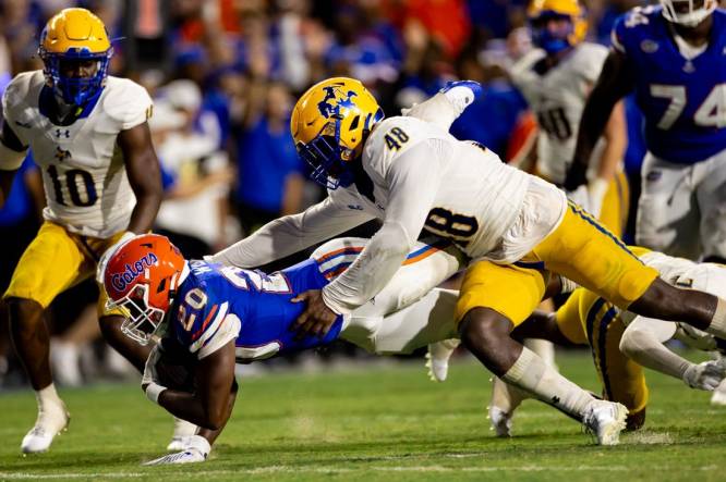 Sep 9, 2023; Gainesville, Florida, USA; Florida Gators running back Treyaun Webb (20) stretches for a first down tackled by McNeese State Cowboys linebacker Micah Davey (48) during the second half at Ben Hill Griffin Stadium. Mandatory Credit: Matt Pendleton-USA TODAY Sports