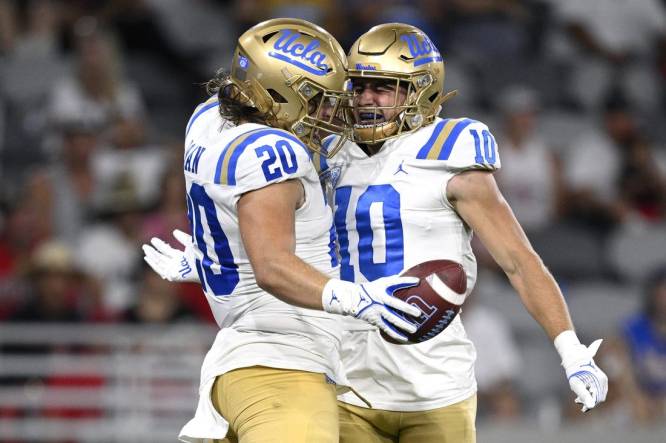 Sep 9, 2023; San Diego, California, USA; UCLA Bruins running back Carsen Ryan (20) celebrates with wide receiver Ryan Cragun (10) after scoring a touchdown against the San Diego State Aztecs during the second half at Snapdragon Stadium. Mandatory Credit: Orlando Ramirez-USA TODAY Sports