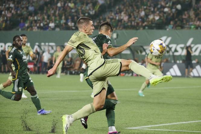 Sep 9, 2023; Portland, Oregon, USA; Los Angeles FC defender Sergi Palencia (30) takes a shot on goal during the first half against Portland Timbers defender Claudio Bravo (5) at Providence Park. Mandatory Credit: Troy Wayrynen-USA TODAY Sports