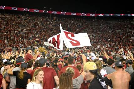Sep 9, 2023; Pullman, Washington, USA; Washington State Cougars fans rush there field after a game against the Wisconsin Badgers at Gesa Field at Martin Stadium. Washington State won 31-22. Mandatory Credit: James Snook-USA TODAY Sports