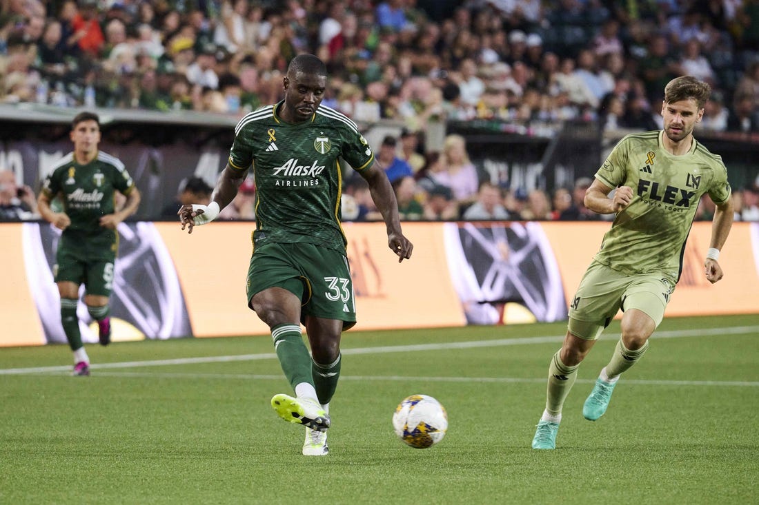 Sep 9, 2023; Portland, Oregon, USA; Portland Timbers defender Larrys Mabiala (33) kicks the ball during the first half against Los Angeles FC forward Mario Gonzalez (9) at Providence Park. Mandatory Credit: Troy Wayrynen-USA TODAY Sports