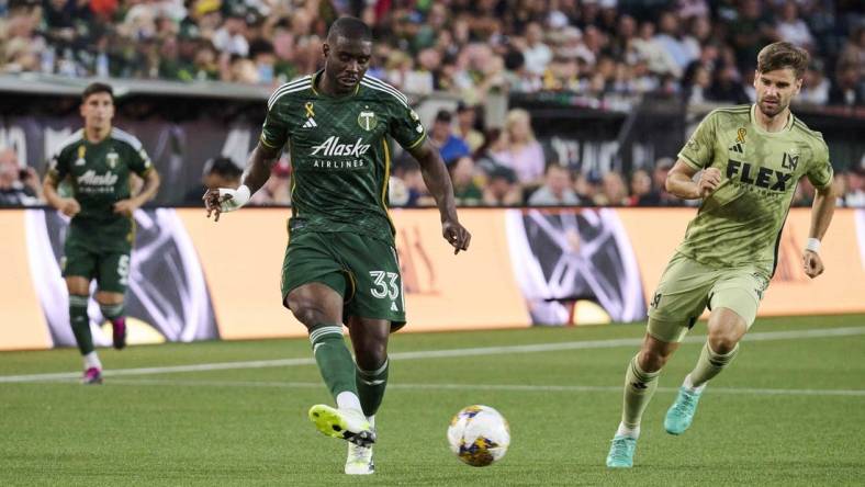 Sep 9, 2023; Portland, Oregon, USA; Portland Timbers defender Larrys Mabiala (33) kicks the ball during the first half against Los Angeles FC forward Mario Gonzalez (9) at Providence Park. Mandatory Credit: Troy Wayrynen-USA TODAY Sports