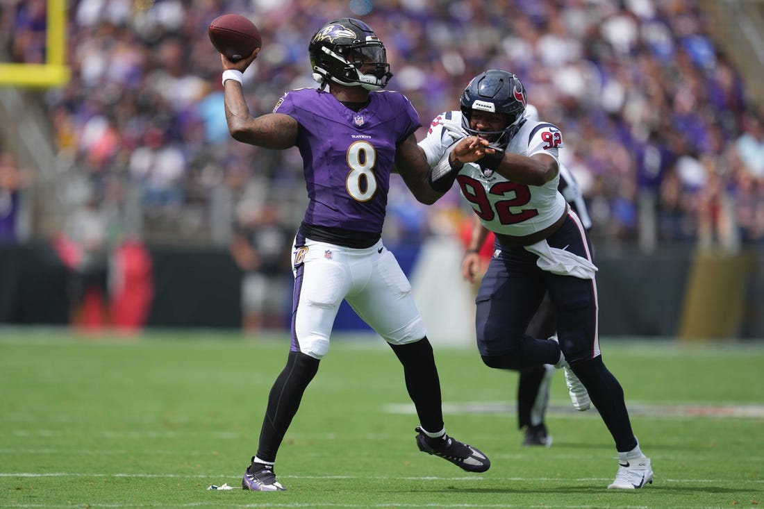 Sep 10, 2023; Baltimore, Maryland, USA; Baltimore Ravens quarterback Lamar Jackson (8) pressured by Houston Texans defensive end Dylan Horton (92) in the first quarter at M&T Bank Stadium. Mandatory Credit: Mitch Stringer-USA TODAY Sports