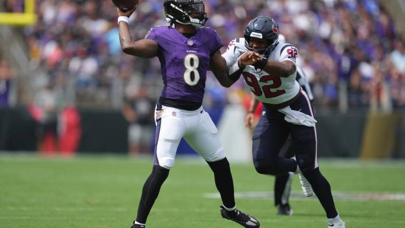 Sep 10, 2023; Baltimore, Maryland, USA; Baltimore Ravens quarterback Lamar Jackson (8) pressured by Houston Texans defensive end Dylan Horton (92) in the first quarter at M&T Bank Stadium. Mandatory Credit: Mitch Stringer-USA TODAY Sports