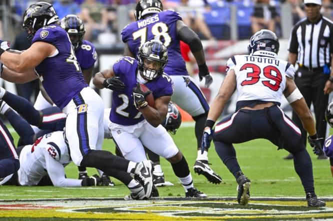 Sep 10, 2023; Baltimore, Maryland, USA; Baltimore Ravens running back J.K. Dobbins (27) carries the ball against the Houston Texans during the first half at M&T Bank Stadium. Mandatory Credit: Brad Mills-USA TODAY Sports